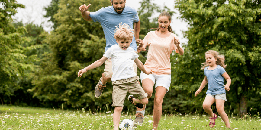 family playing soccer summer